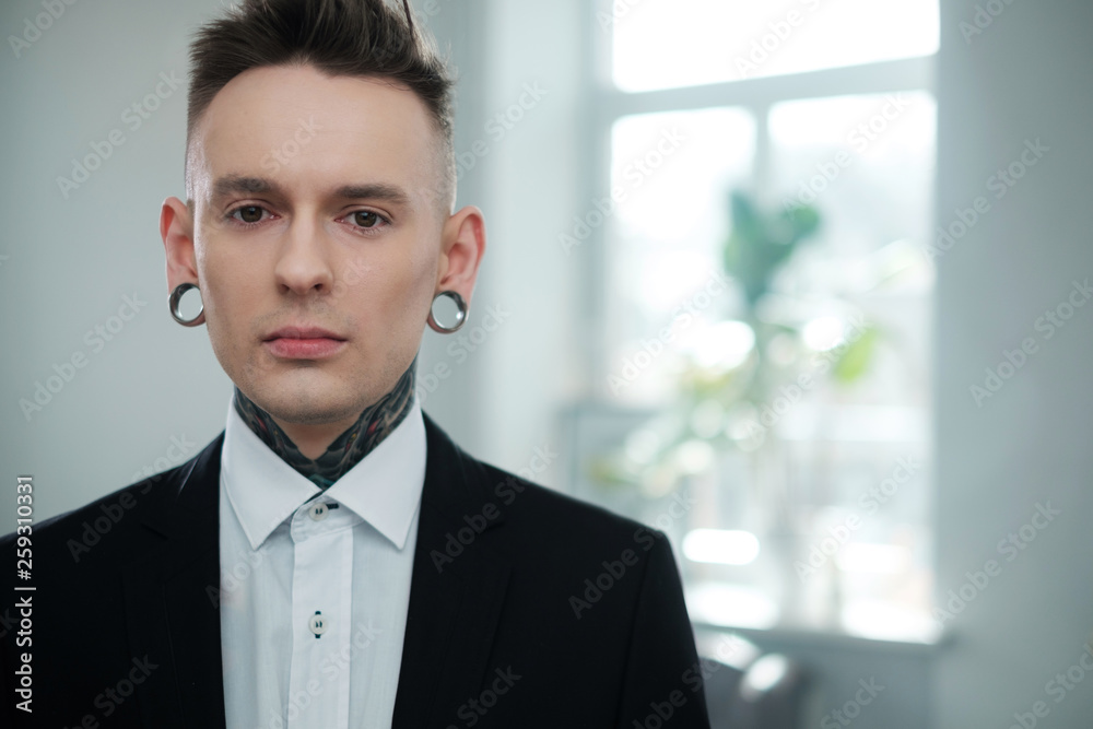 Portrait of alternative model with earplugs and tattoo Portrait of alternative model with earplugs and tattoo