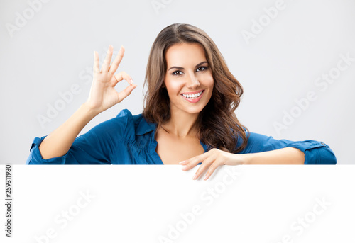 Young woman showing blank signboard