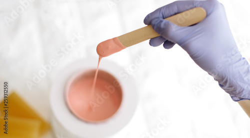hot pink wax in white bowl for Hair removal on white background
