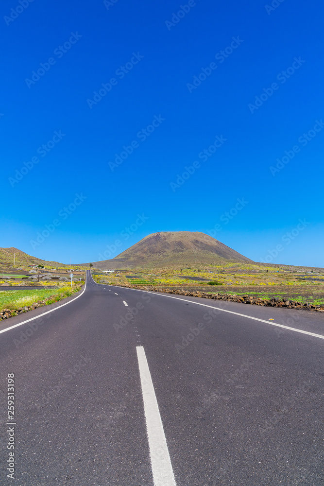 Spain, Lanzarote, Endless long street to monte corona volcano mountain