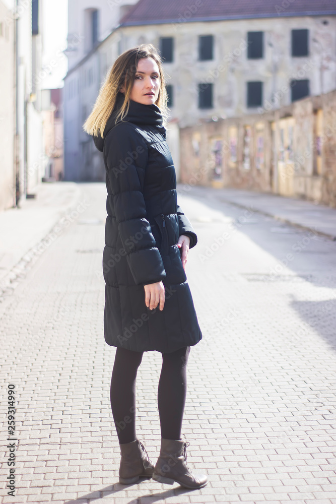 Young woman walking down the old street. Young woman walking down the old street.