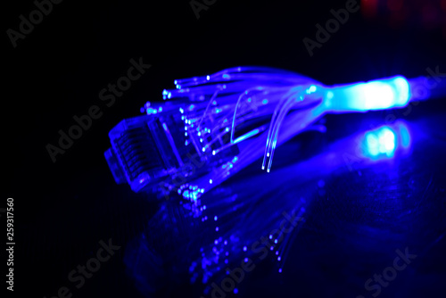Network cable with fiber optics light on black background