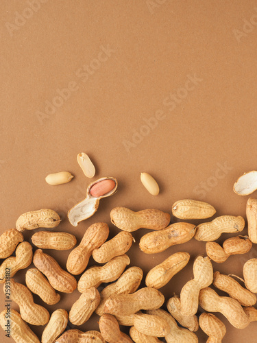 Organic peanuts on a brown background photo