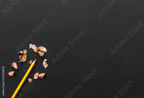Yellow pencil on blackboard banner background. top view with copy space.