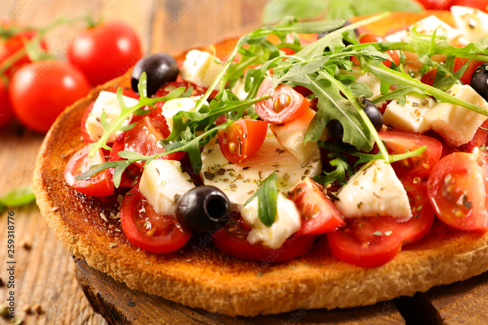 italian bruschetta with tomato, mozzarella, olive and basil italian bruschetta with tomato, mozzarella, olive and basil
