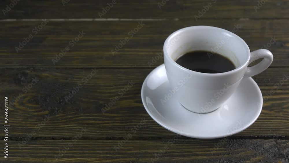 Cup of coffee on a rough wooden background Cup of coffee on a rough wooden background