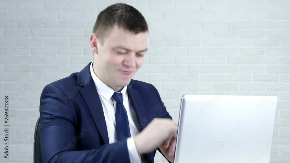 Charismatic funny businessman chatting on laptop Charismatic funny businessman chatting on laptop