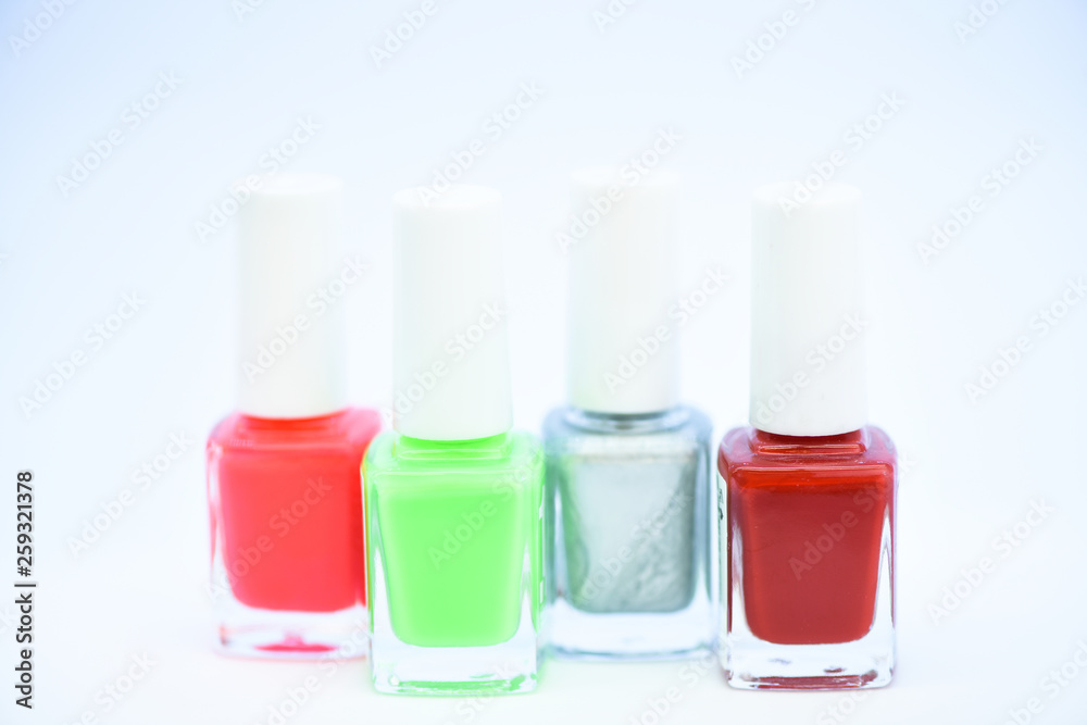 Nail polish white background. Durability and quality polish coating. Gel polish modern technology. How to combine colors. Manicure salon. Fashion trend. Nail polish bottles. Beauty and care concept Nail polish white background. Durability and quality polish coating. Gel polish modern technology. How to combine colors. Manicure salon. Fashion trend. Nail polish bottles. Beauty and care concept