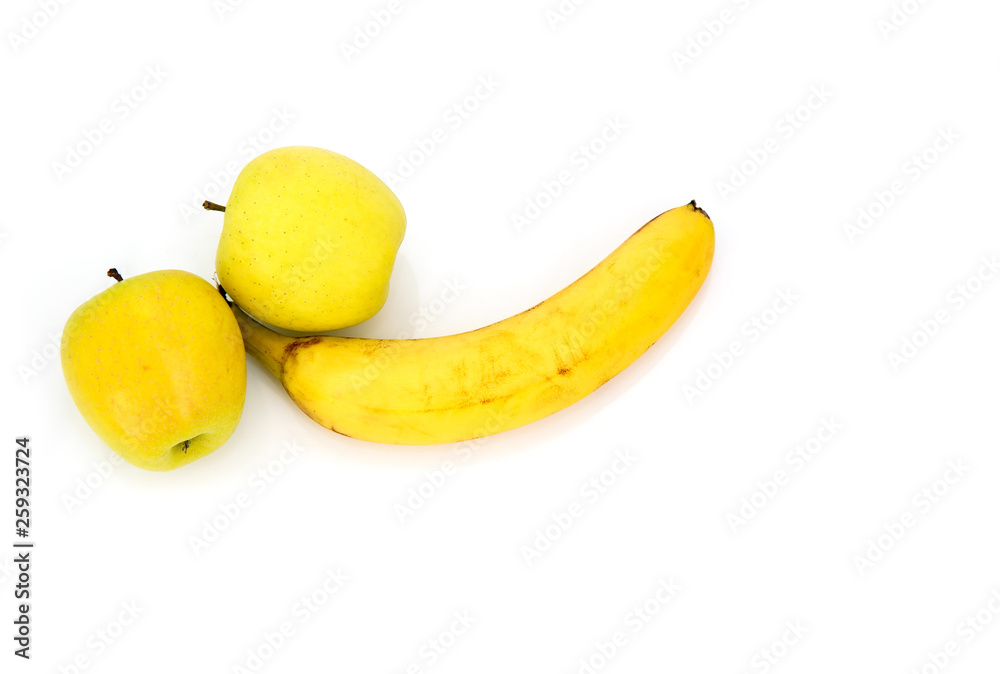 Banana and two yellow apples isolated on white background. Concept of male potency. Banana and two yellow apples isolated on white background. Concept of male potency.