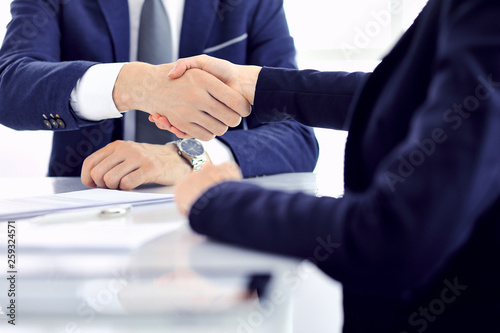 Group of business people or lawyers shaking hands finishing up a meeting   close-up. Success at negotiation and handshake concepts