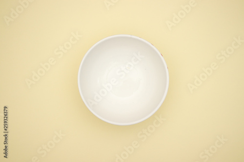 Pasta in white dish on yellow background