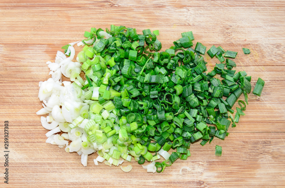 Chopped green onion on woode board. Top view Chopped green onion on woode board. Top view