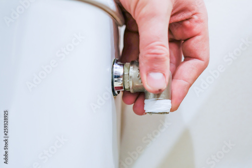 Sanitary worker performs repair of toilet bowl