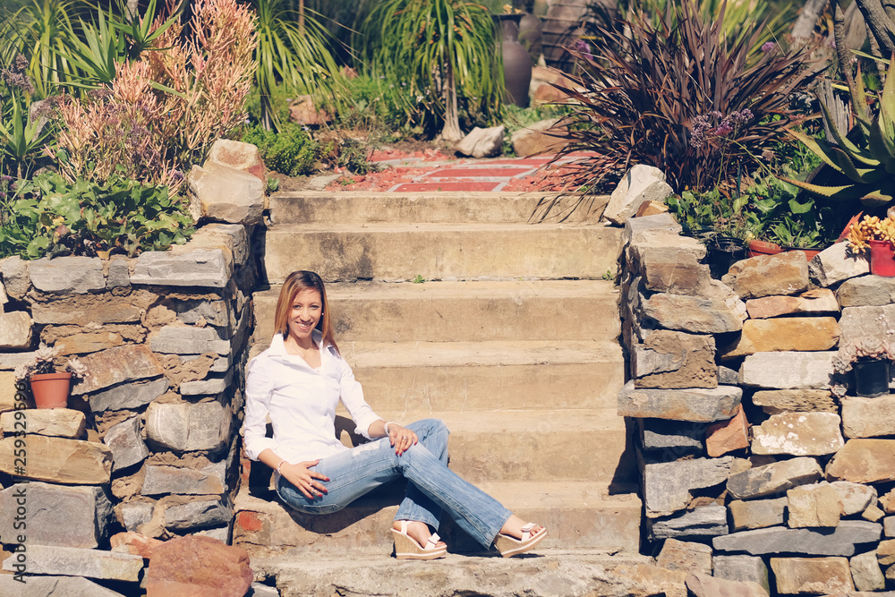 Fototapeta premium African-American lady in jeans in the garden