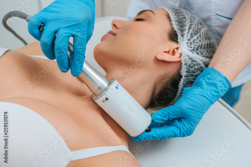 Cropped view of cosmetologist doing therapy for neck