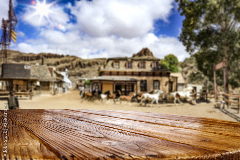 Desk of free space for your decoration. Summer city. Western architecture and running horses Desk of free space for your decoration. Summer city. Western architecture and running horses
