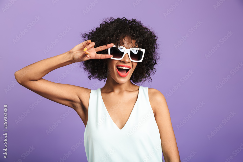 Pleased pretty african woman showing peace gesture Pleased pretty african woman showing peace gesture