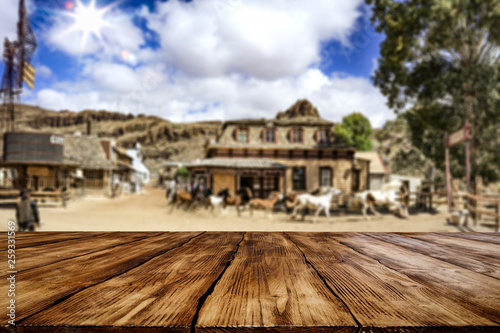 Desk of free space for your decoration. Summer city. Western architecture and running horses