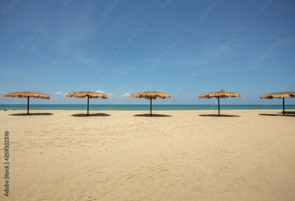 Straw umbrella on the beach for summer vacation tropics,Concept: Lifestyle for leisure travel,symbol tourism for island By the sea Straw umbrella on the beach for summer vacation tropics,Concept: Lifestyle for leisure travel,symbol tourism for island By the sea