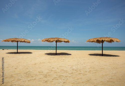 Straw umbrella on the beach for summer vacation tropics,Concept: Lifestyle for leisure travel,symbol tourism for island By the sea