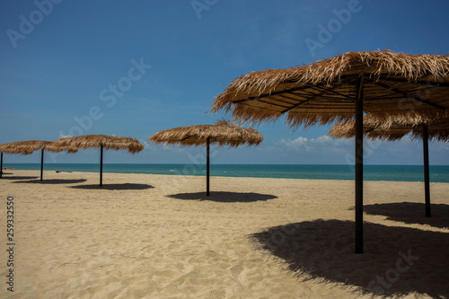Fototapeta Naklejka Na Ścianę i Meble -  Straw umbrella on the beach for summer vacation tropics,Concept: Lifestyle for leisure travel,symbol tourism for island By the sea