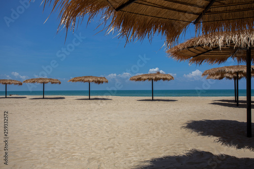 Fototapeta Naklejka Na Ścianę i Meble -  Straw umbrella on the beach for summer vacation tropics,Concept: Lifestyle for leisure travel,symbol tourism for island By the sea