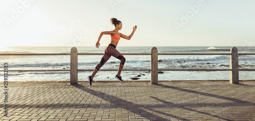 Woman sprinting on promenade