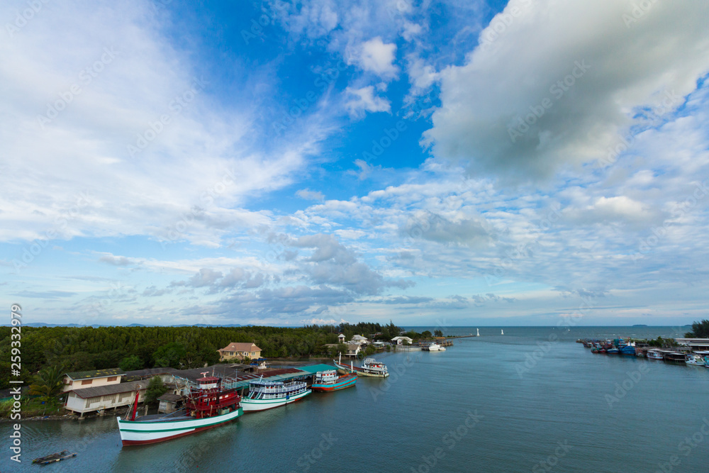 Fototapeta premium View of boat and sea and city when look from prasae bridge in the evening at rayong province , thailand.