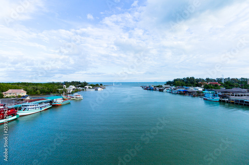 View of boat and sea and city when look from prasae bridge in the evening at rayong province , thailand.