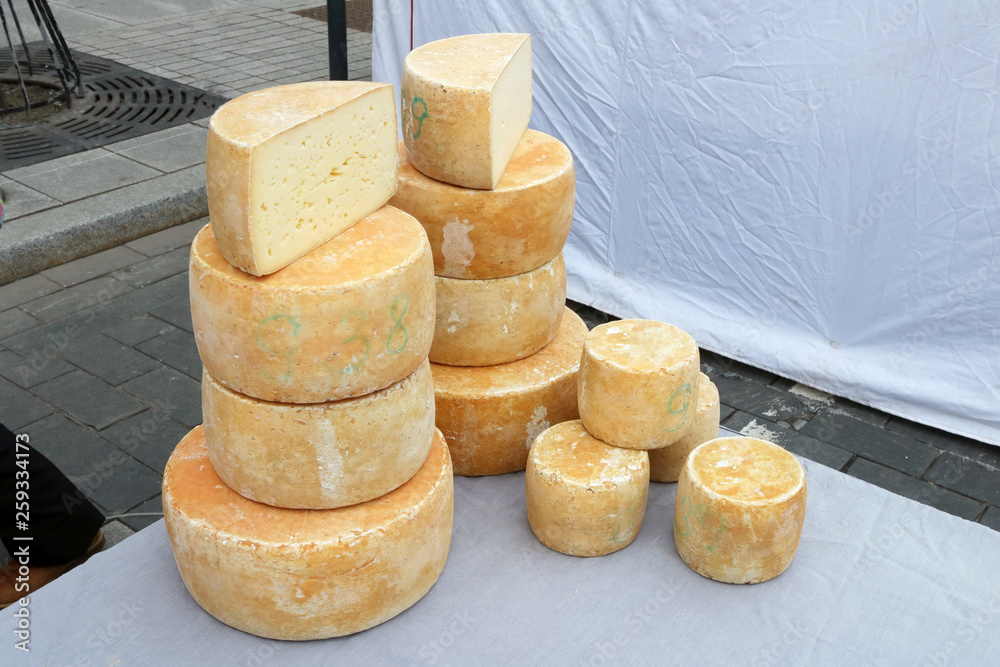 Homemade rustic semi-hard cheese sold on the street during the spring fair