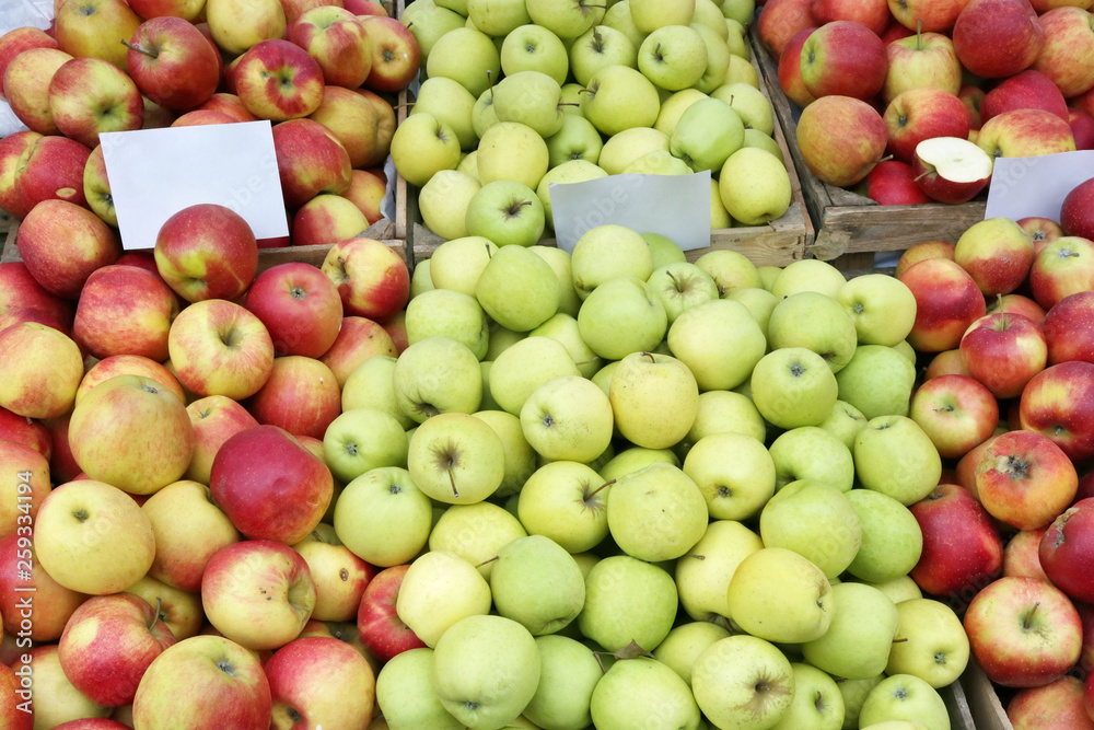 Street market of fresh  red and green garden apples fruits  in wooden boxes