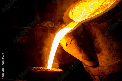 metal casting process with red high temperature fire in metal part factory
