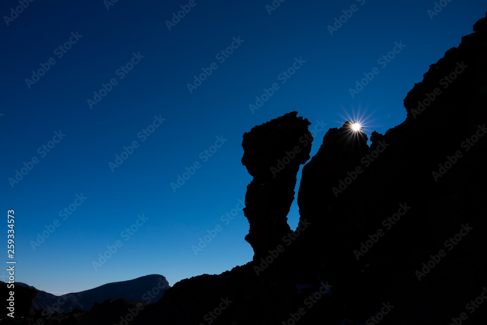 Star sun behind iconic rocks in Tenerife