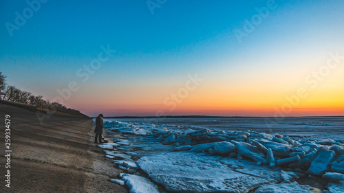 Frozen sea. Snow landscape. Sunset
