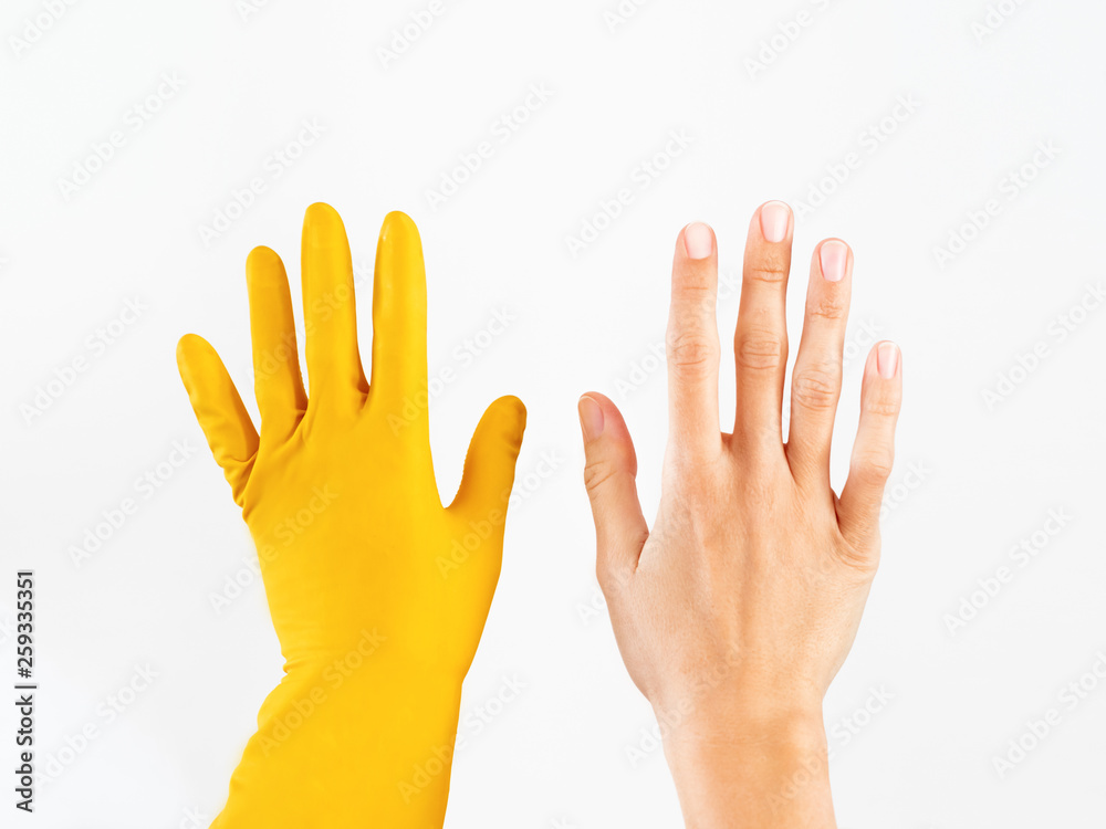 Woman hands on white background. Left hand in yellow rubber glove ...