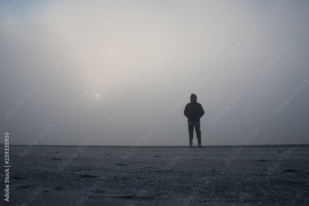 Man disappearing in the white fog