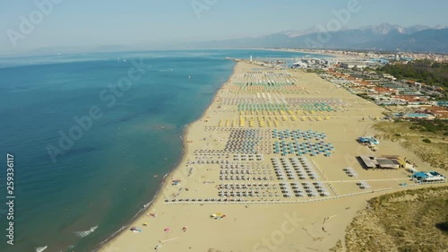 Aerial, large sand beach in the morning in Viareggio, Italy