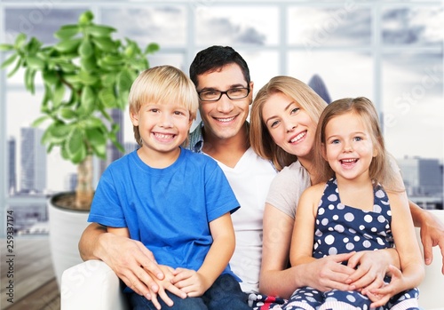 Young  family at home smiling at camera