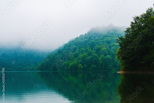 mountain lake in the misty morning