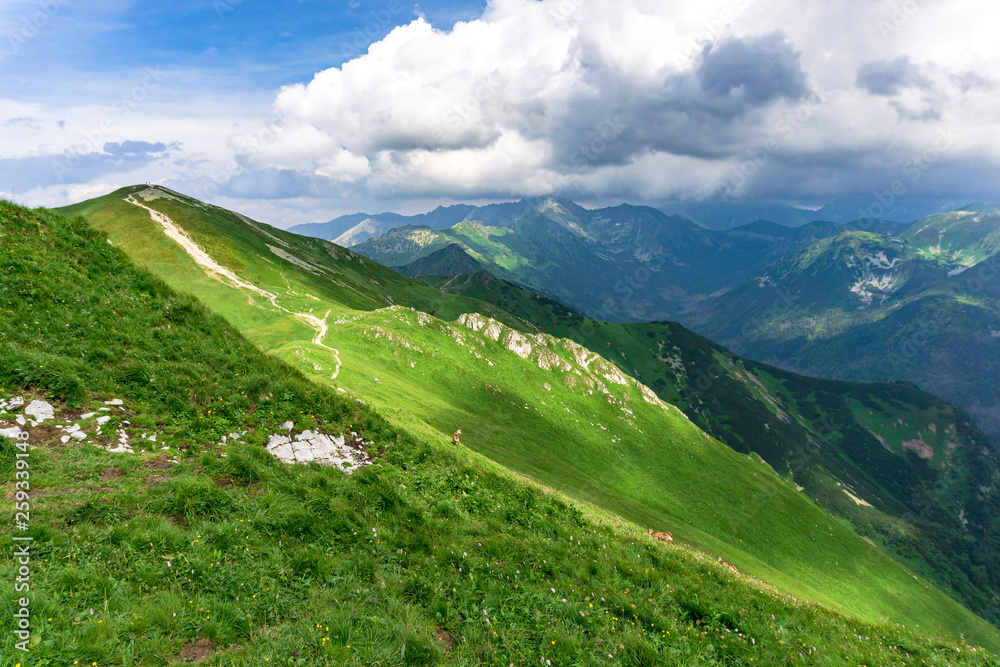 Obraz premium Whirling clouds over the peaks of the Tatra Mountains in June.