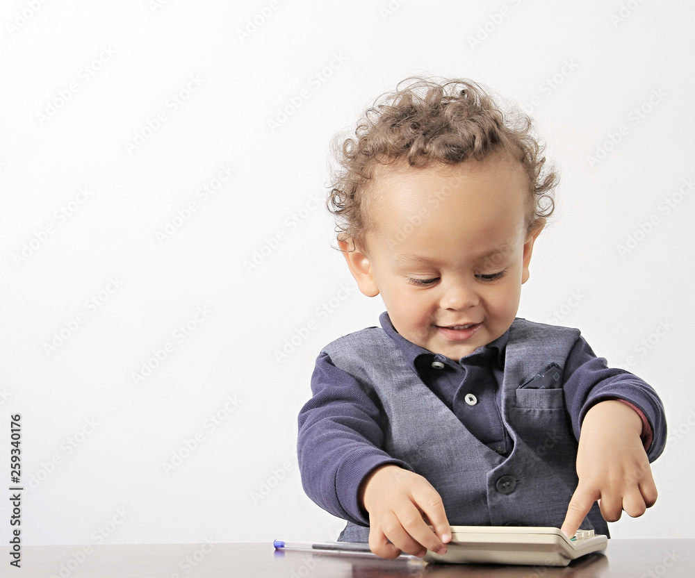 little boy with calculator and pen on table with white background stock photo little boy with calculator and pen on table with white background stock photo