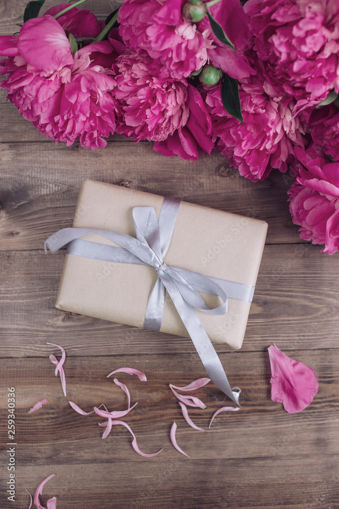 Pink peony flowers gift box cup on brown rustic table. Mothers day or Womens day Pink peony flowers gift box cup on brown rustic table. Mothers day or Womens day