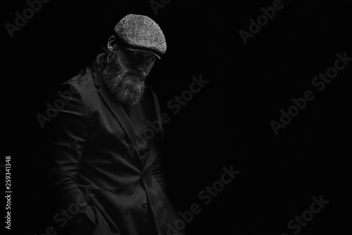 black and white brutal man in a hat with a beard
