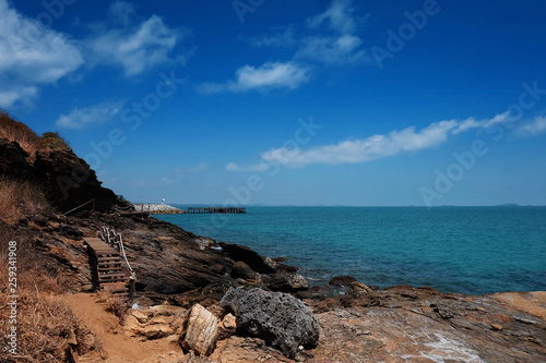 wooden bridge walkway along the rocks coast and sea with blue sky summer time with day light background