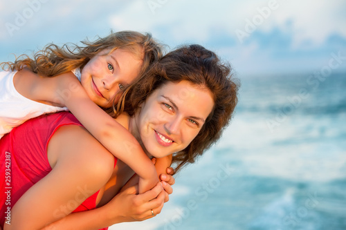 Portrait of happy mother and little daughter on sunny beach on Maldives at summer vacation © sborisov
