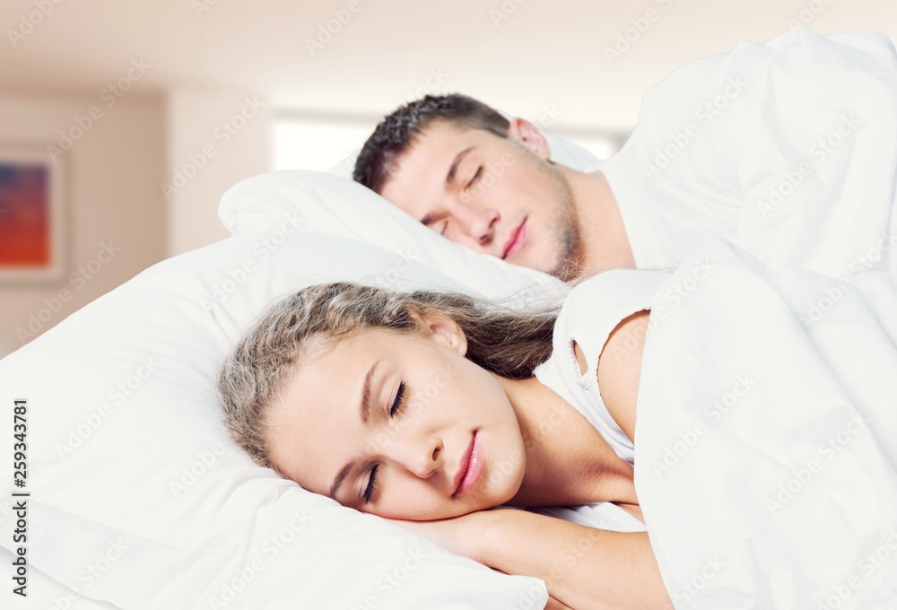 Young couple sleeping on the bed in bedroom Young couple sleeping on the bed in bedroom