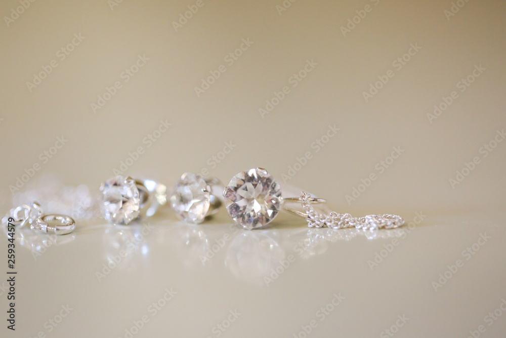 Silver earrings with crystal stone, selective focus