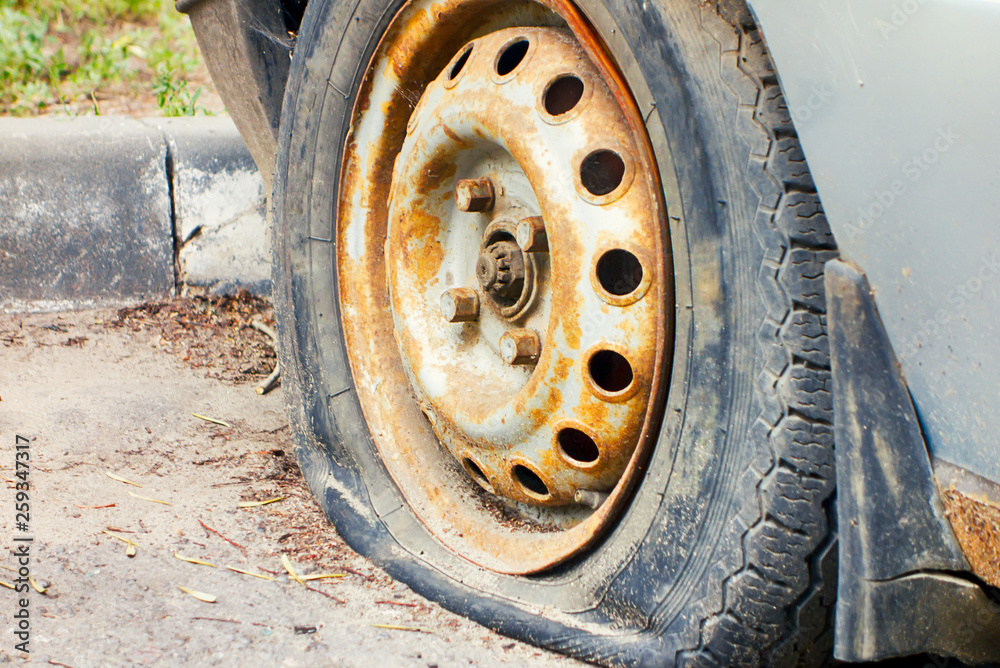 Flat tire of old car outdoors. Flat tire of old car outdoors.