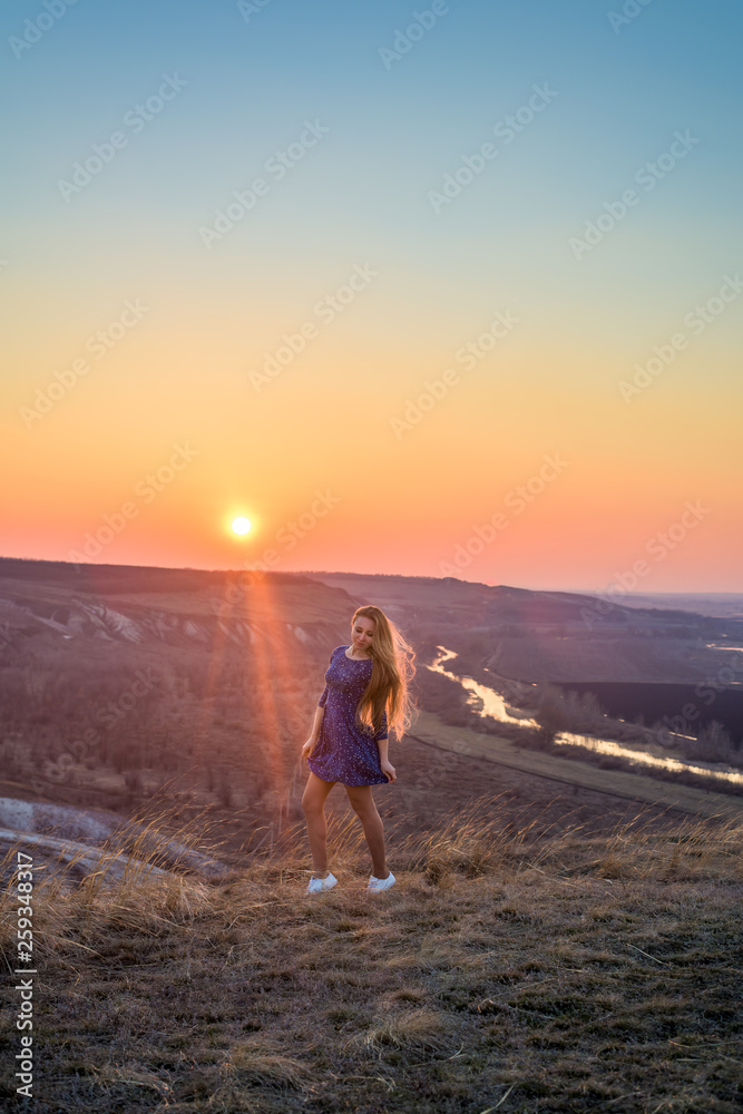 the girl in the sunset. vertical image