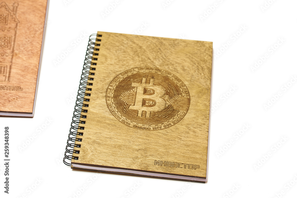notebook cut out of wood with the help of a laser in the hands of man on a white background notebook cut out of wood with the help of a laser in the hands of man on a white background